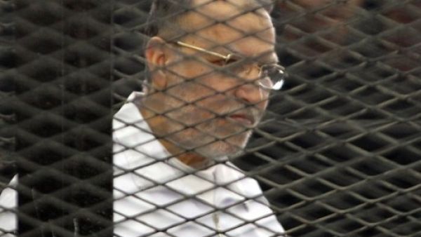 Mohammed Badie along with 34 co-defendants, such as Essam Al Eryan, are on trial for protest killings and inciting violence during the June 30 demonstrations (Maher Iskander/AFP)