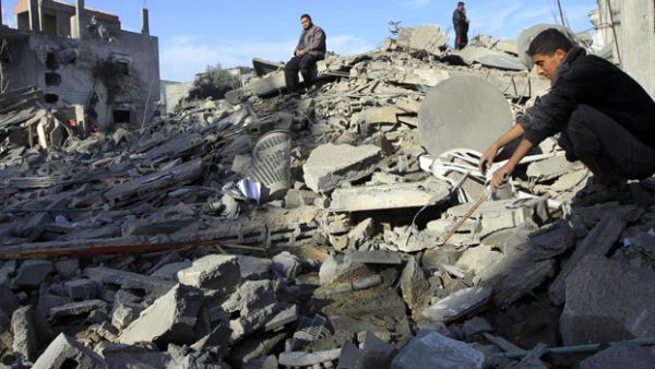 A man sifts through the rubble of his home in the Gaza Strip following an Israeli airstrike. (AFP/File)