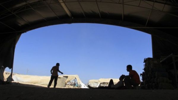  A Palestinian worker rests at the entrance of a smuggling tunnel dug beneath the Gaza-Egypt border in the southern Gaza Strip on August 27, 2013. (AFP)