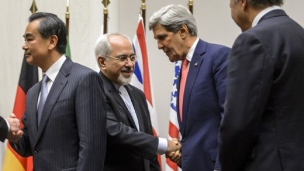 Iranian Foreign Minister Mohammed Javad Zarif, pictured here with US Secretary of State John Kerry, announced on Twitter early Sunday that a preliminary deal between Tehran and the world powers had been reached (Fabrice Coffrini/AFP)