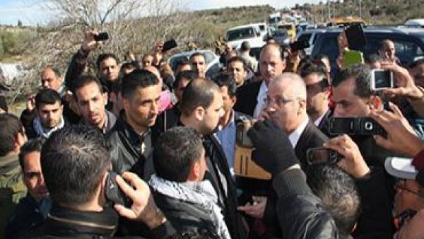 An angry Hamdallah got out of his car and hurled accusations at the army for unjustly pulling over his convoy. [Farah Studio]