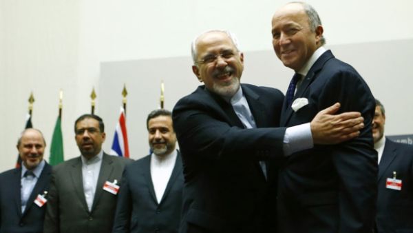 Iranian Foreign Minister Mohammad Javad Zarif hugs French Foreign Minister Laurent Fabius after a ceremony at the United Nations in Geneva on Nov. 24, 2013. 
