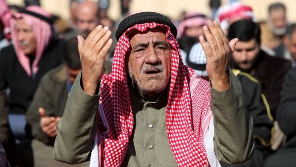 An Iraqi Muslim Sunni man prays during the weekly Friday noon prayers before an anti-government protest outside the Sunni Umm al-Qura mosque in Baghdad on Friday (Photo: AFP/AHMAD AL-RUBAYE)