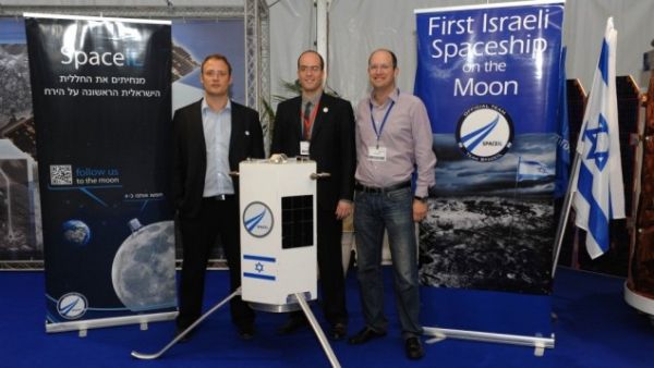 Three of SpaceIL's founders -- Yariv Bash, Yonatan Winetraub, and Kfir Damari -- with a model of the spacecraft they propose to send to the moon (photo: Times of Israel / Alon Hadar)