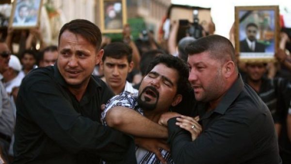 عراقي ينتحب اثناء جنازة زوار شيعة قتلوا اثناء توجههم من كربلاء الى سوريا