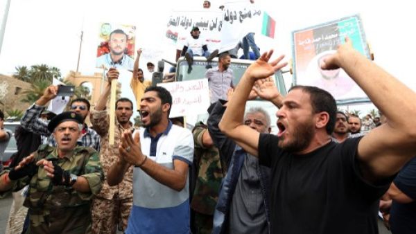 Libyan protesters hold placards and banners during a demonstration in support of the "political isolation law" in Libya's landmark Martyrs Square on May 5, 2013 in Tripoli, Libya. (Photo: AFP / Mahmud Turkia) 