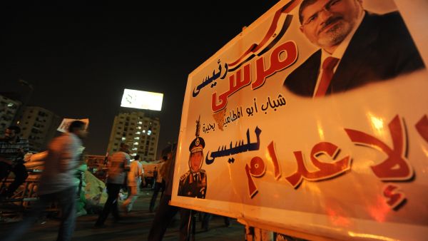 A protest sign showing deposed president Mohamed Morsi hangs in Cairo on July 31. (AFP / Fayez Nureldine)
