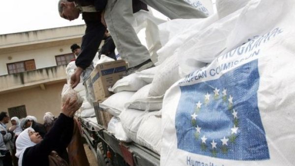 سيدة فلسطينية تتسلم مساعدة غذائية من الاتحاد الاوروبي عن طريق برنامج الغذاء العالمي توزعها الانروا، في جنين
