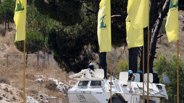 UN peacekeepers patrol past Hezbollah flags on July 23. (AFP / Mahmoud Zayyat)