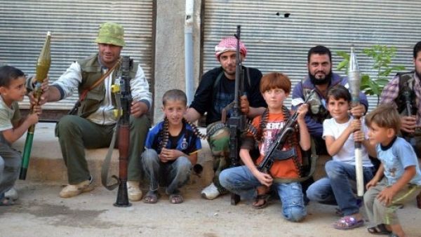 Members of the FSA pose with local children 