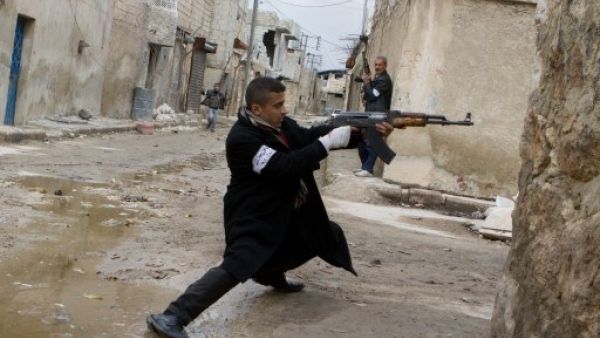 A Syrian rebel aims his weapon during clashes with government forces in the streets near Aleppo international airport in northern Syria on Monday (Photo: AFP/Stephen J. Boitano) - Picture used for illustrative purposes -
