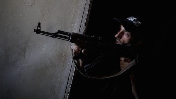 A rebel fighter points his gun towards pro-government forces' positions during clashes in the Salaheddine district of the northern Syrian city of Aleppo, on July 9, 2013. (Source: AFP/JM LOPEZ)