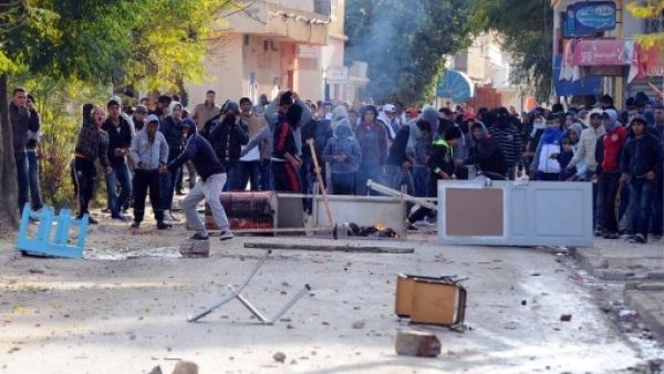 Tunisian protestors hurled stones at security officials late last week, calling for the ruling Islamist party Ennahda's resignation (Fethi Balaid/AFP)