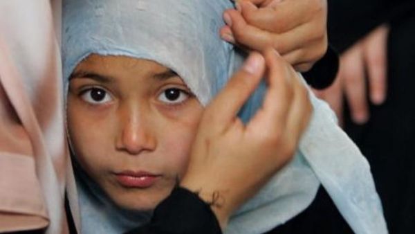 One young girl in Gaza tries on the veil 