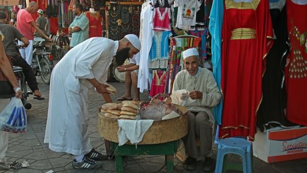 A man selling bread in front of a shop in Marrakesh. (Pixabay)