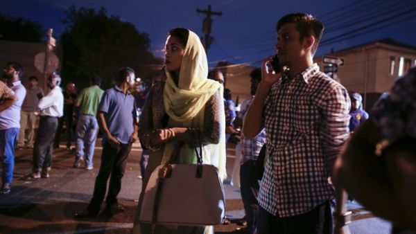 Community members pray outside the Al-Furqan Jame Mosque in Queens, NY. (AFP/Kena Betancur)