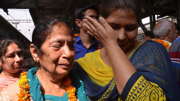 Indian resident Santosh is met by relatives after being evacuated following an earthquake in Nepal at the railway station in Amritsar on April 27, 2015. (AFP/Narinder Nanu)