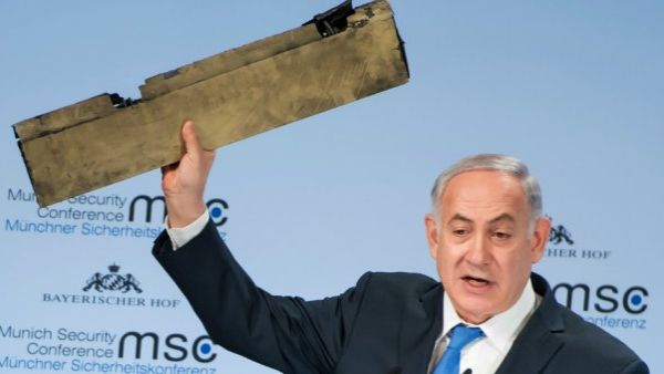 Israel’s prime minister has said his regime could “act” directly against Iran, showing off what he called a piece of an Iranian drone which the Israeli military claims to have downed more than a week ago. (AFP) 