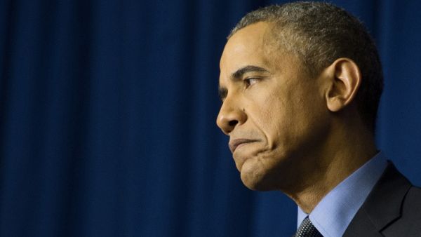 US President Barack Obama reacts during a press conference at the Organization for Economic Co-Operation and Development Centre in Paris on December 1, 2015. (AFP/Jim Watson)