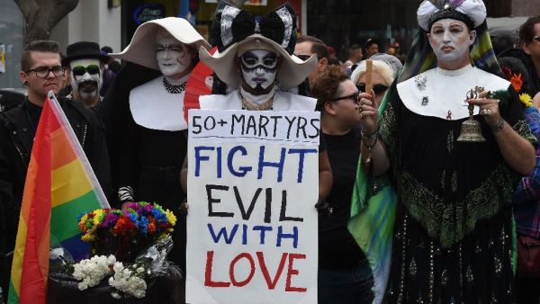Participants in Los Angeles' gay pride parade show their solidarity for the victims of a mass shooting - the largest in U.S. history - that killed at least 50 people at a popular gay nightclub in Orlando, Florida.  (AFP/Mark Ralston)
