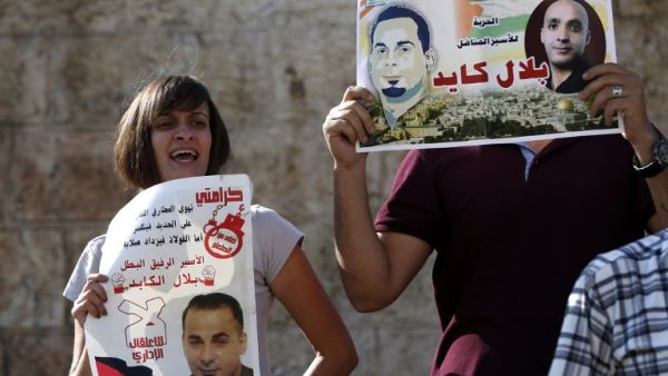 Palestinian protestors hold posters of Bilal Kayed, protesting his administrative detentio at Damascus Gate, a main entrance to Jerusalem's Old City. (AFP/Ahmad Gharabli)