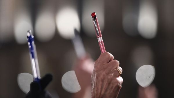 Demonstrators hold up pens in solidarity with last year's slain Charlie Hebdo journalists in France. (AFP/Damien Meyer)