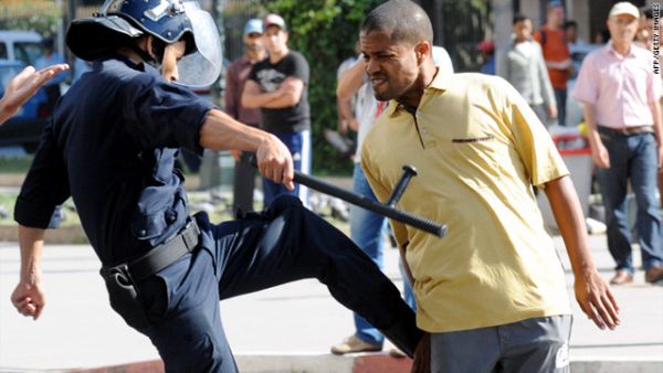 A police officer kicks a demonstrator during a protest in Rabat, Morocco. (AFP/File)