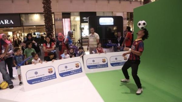 Free Styler wows the visitors by performing soccer tricks at the UAB stand organised for the bank's alliance with FC Barcelona