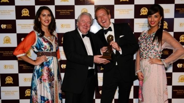 Alexander Schneider (right) pictured with awards hostesses and Graham Cooke – President and Founder of World Group (left)