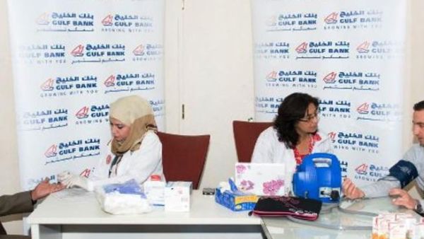 Gulf Bank employees during a blood test which occurs before donating blood Gulf Bank employees during a blood test which occurs before donating blood