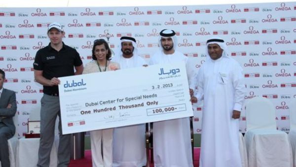 DDC champion Stephen Gallacher with Dr. Maushid from Dubai Center for Special Needs receiving the cheque from Mohamed Yahya