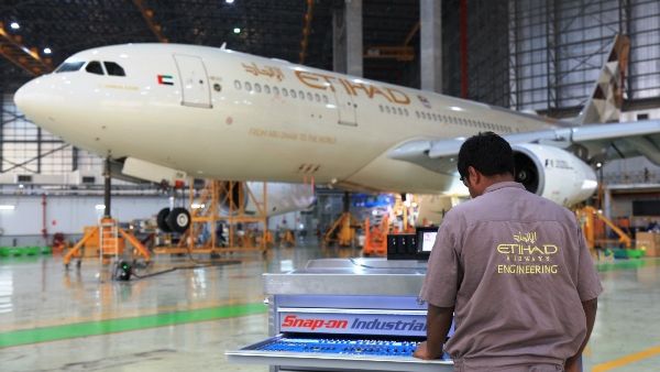 An aircraft engineer accessing the new Automated Tool System in front of an Etihad Airways’ A330 aircraft undergoing routine maintenance