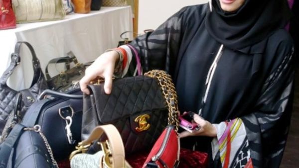Eman Al Mansoori, Marketing Manager at Dubai Ladies Club with a selection of designer bags in 2010