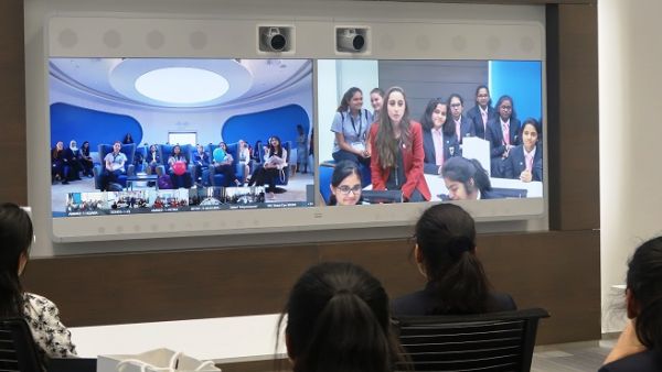 Girls engaging with Cisco Execs using Cisco's Telepresence technology.