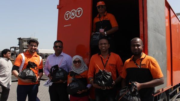 TNT Team Members distribute food packs to Seafarers in Sharjah.