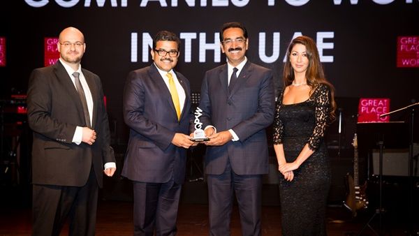 UAE Exchange CEO Promoth Manghat (left) and UAE Exchange President Y Sudhir Kumar Shetty (right) recieving the Great Place to Work Award