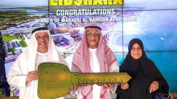 Khalid Rafea, Executive Manager and Head of Retail Banking Group at KFH-Bahrain with the winner Ebrahim Bukhamas.