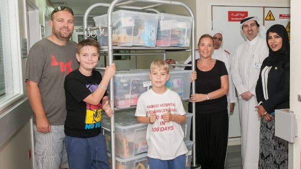 Fundraiser Finn Froud with toy packages for child cancer patients at Hamad General Hospital
