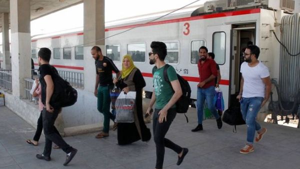 Iraqi passengers disembark from a train coming from Baghdad as it arrives in the city of Fallujah in Anbar province, about 70 kilometers west of the capital. (AFP)