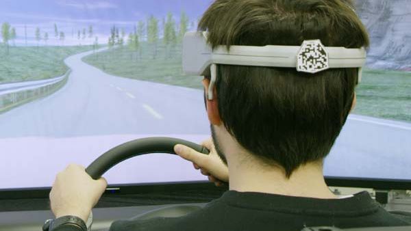 The driver wears a device that measures brain wave activity, which is then analyzed by autonomous systems. 