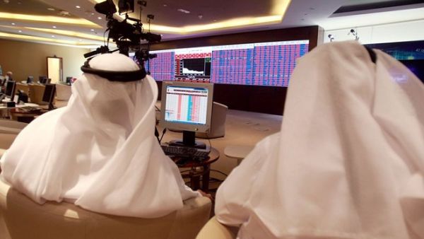 Traders monitor screens displaying stock information at Qatar Stock Exchange in Doha on June 5, 2017. (Reuters)