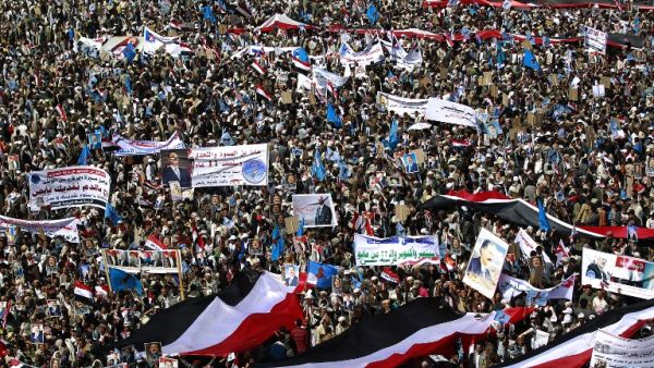 Yemenis wave national flags and hold placards during a protest against the Saudi-led coalition, commemorating one year of the alliance's military campaign against insurgents on March 26, 2016 next to the Monument to the Unknown Soldier in the Yemeni capital Sanaa. (AFP/Mohammed Huwais) Yemenis wave national flags and hold placards during a protest against the Saudi-led coalition, commemorating one year of the alliance's military campaign against insurgents on March 26, 2016 next to the Monument to the Unknown Soldier in the Yemeni capital Sanaa. (AFP/Mohammed Huwais)