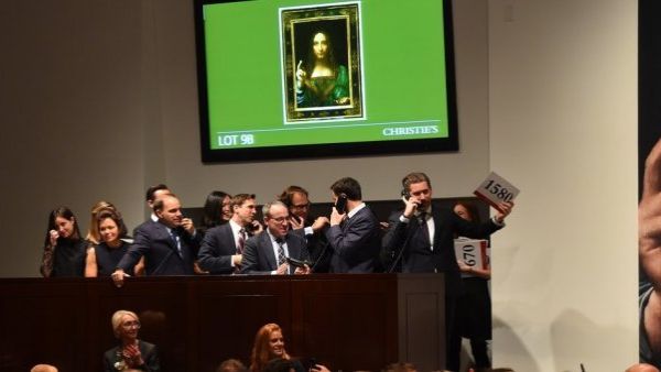 Christie's employees take bids for Leonardo da Vinci's "Salvator Mundi" at Christie's New York (AFP/File Photo)	