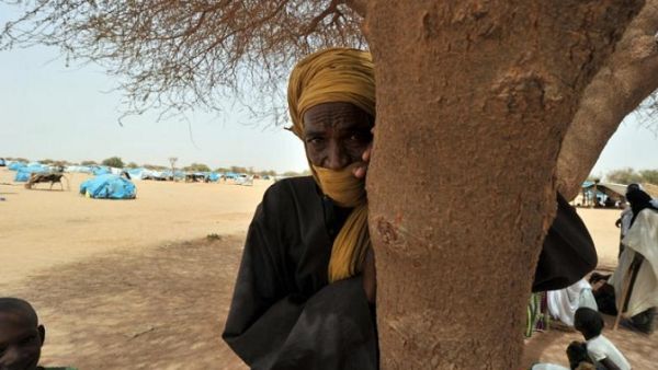 An elderly refugee from northern Mali stands under the shade of a tree at the Mangaize refugee camp on June 2, 2012. (Issouf Sanogo/ AFP)
