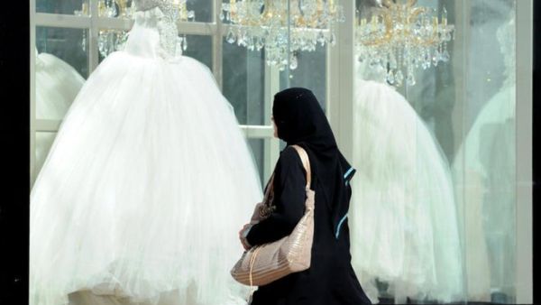 A Saudi woman looks at wedding dresses in a shop. (AFP/File)