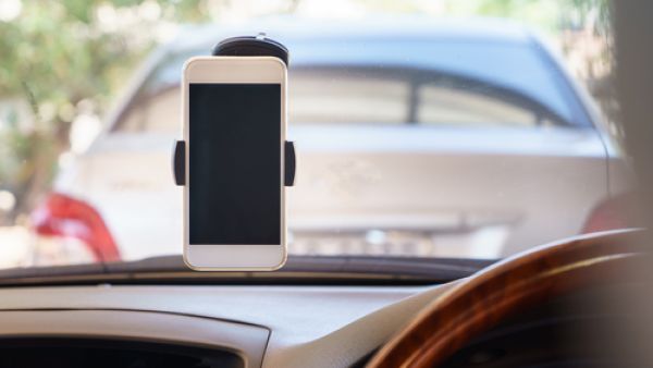 “Installation of a tool or a device to place the mobile phone or any other electronic device for the driver use will attract (a fine of) 15 rial with one black point,” according to the new law (Shutterstock/File)