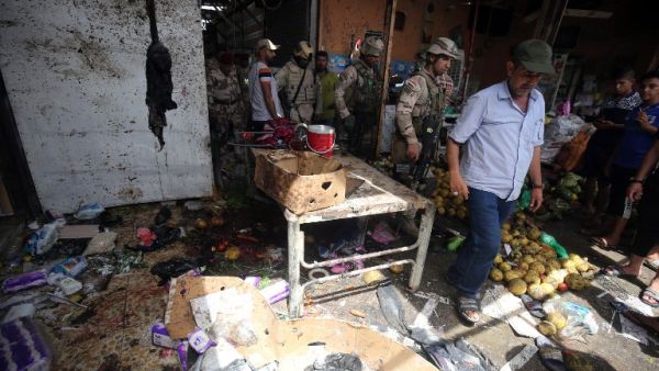 Iraqi security forces gather at the site of a suicide bombing in northern Baghdad on May 17, 2016. (AFP/Ahmad Al-Rubaye)