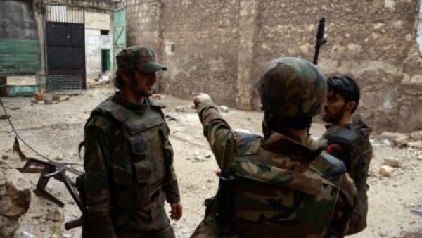 Syrian army soldiers discuss their next month in the city of Aleppo. (AFP/File)