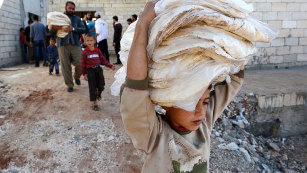 A Syrian boy carries bread in the northern Syrian town of Atareb in the Aleppo province on Nov. 7, 2012. (AFP/File)