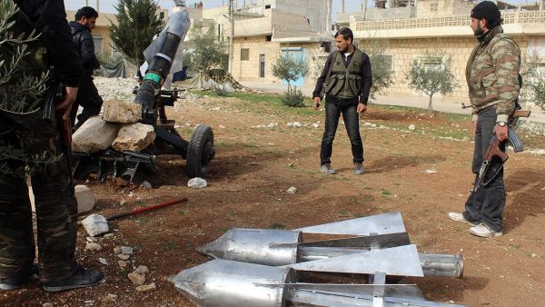 Opposition fighters load a homemade rocket launcher during clashes with government forces in the town of Khan Sheikhun, in Syria's Idlib province. (AFP/File)